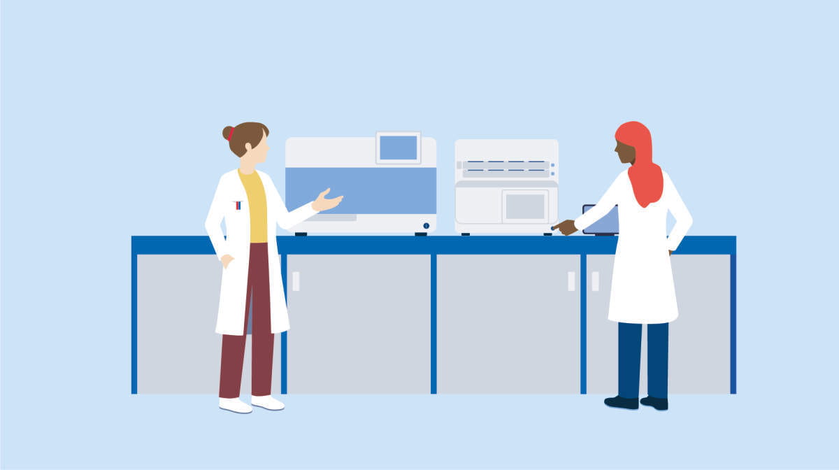 People in a lab coats, standing next to Qiagen equipment